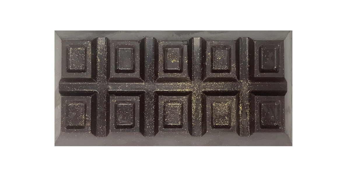 Dark Milk and Yellow Chocolate bar stuffed with Yellow Buttercream Frosting, Chocolate and Yellow Cake, topped with Gold Dust