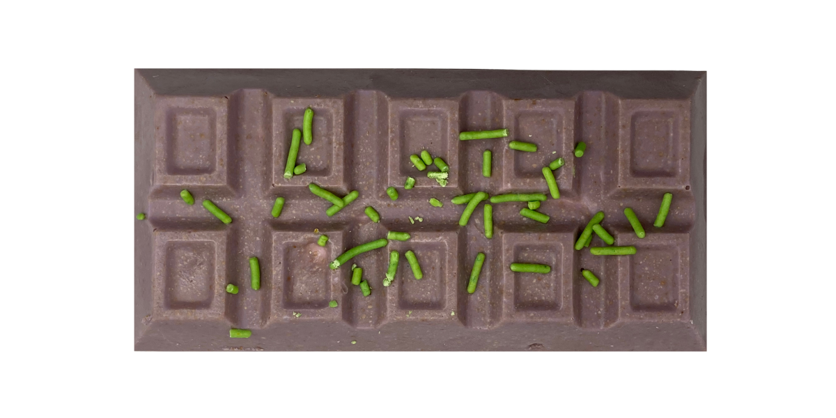 Purple Monster Mash chocolate bar stuffed with marshmallow cream, Snickers, Twix, M&MS & Vanilla Biscuit; topped with green sprinkles
