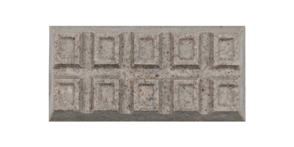 Close-up of a rectangular white chocolate bar with a speckled cookies-and-cream appearance, divided into raised square segments in a grid pattern